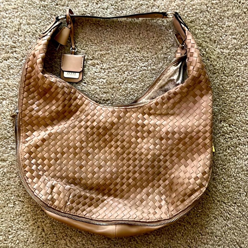 Adorable guess tan hobo bag with giant zippers. Never used.